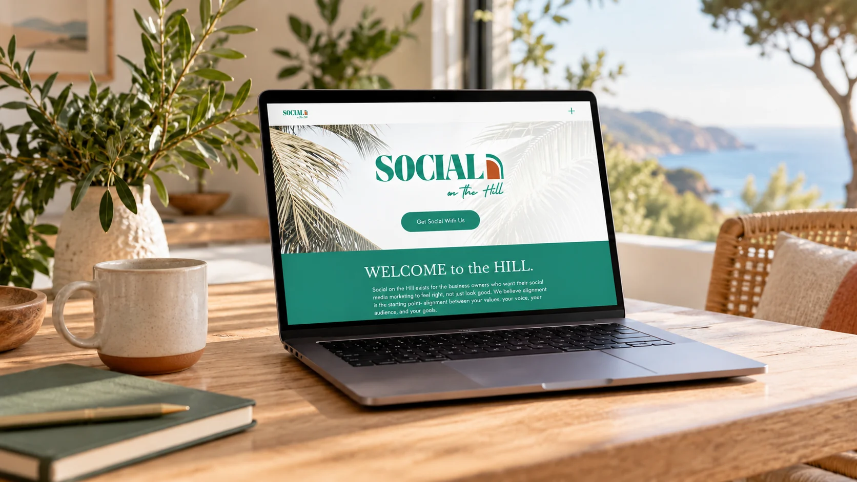 Laptop displaying a website in a coastal workspace